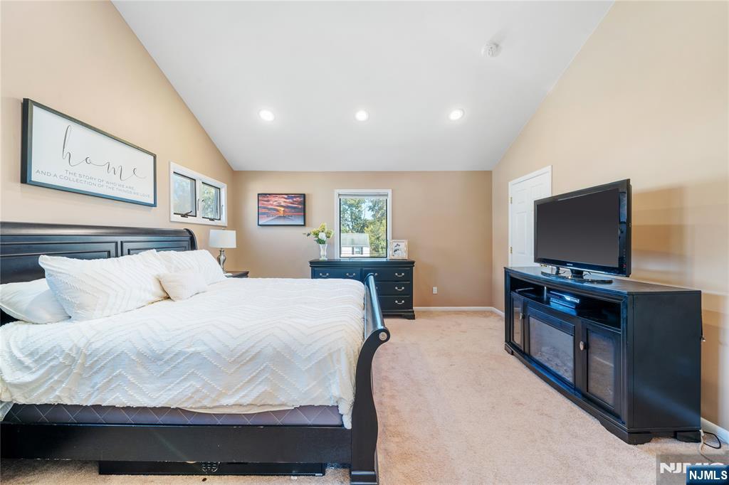 25 Glenview Road Nutley, NJ 07110 - Photo 27 of 49 a bedroom with a bed and a flat screen tv