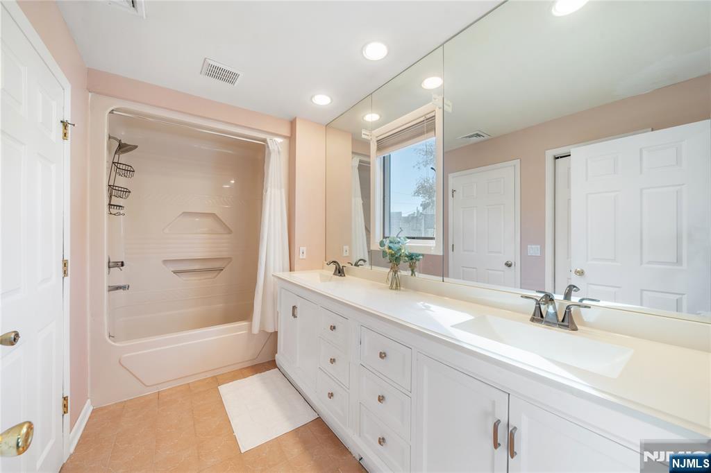 25 Glenview Road Nutley, NJ 07110 - Photo 35 of 49 a bathroom with a tub sink and mirror