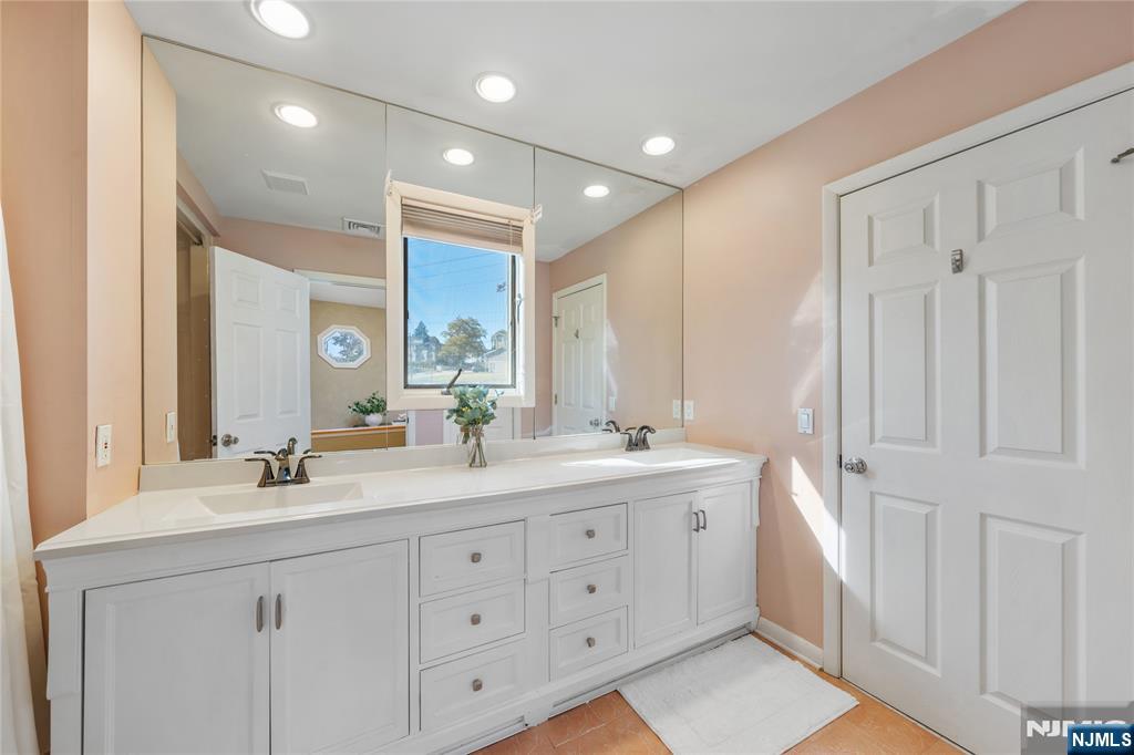 25 Glenview Road Nutley, NJ 07110 - Photo 36 of 49 a bathroom with a double vanity sink and mirror