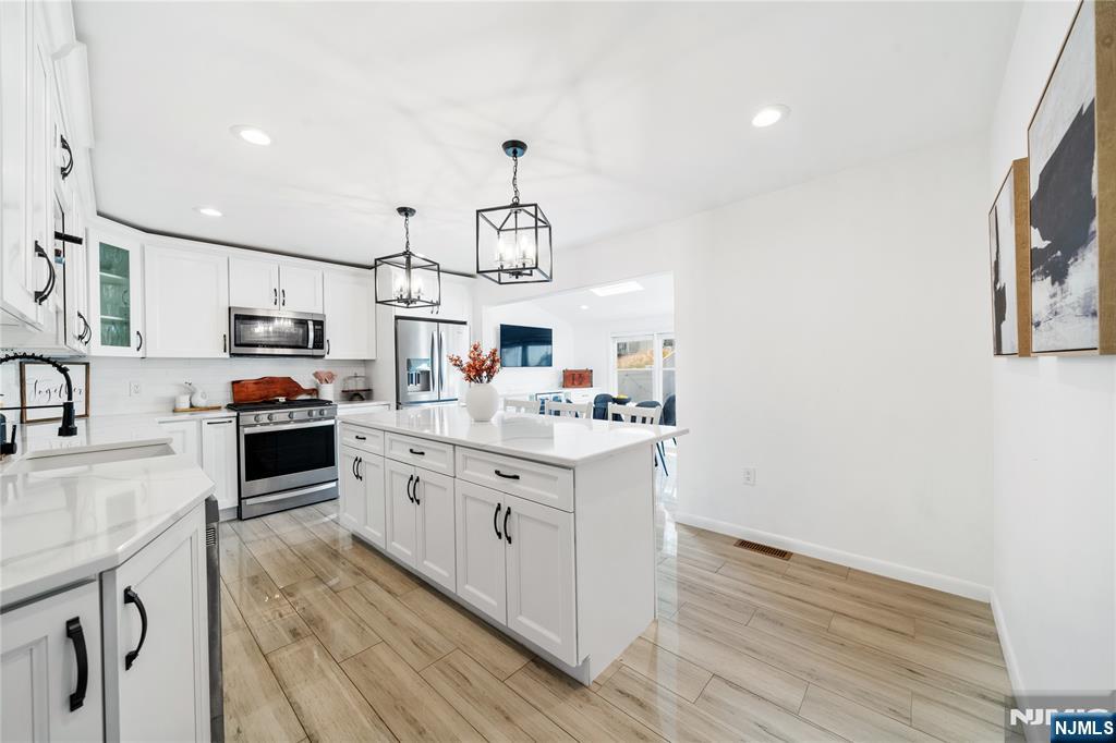 25 Glenview Road Nutley, NJ 07110 - Photo 9 of 49 a kitchen with stainless steel appliances granite countertop a lot of counter space and wooden floors