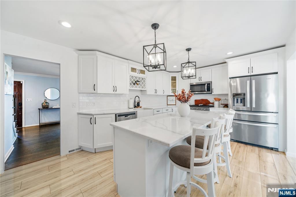25 Glenview Road Nutley, NJ 07110 - Photo 10 of 49 a kitchen with white cabinets and stainless steel appliances