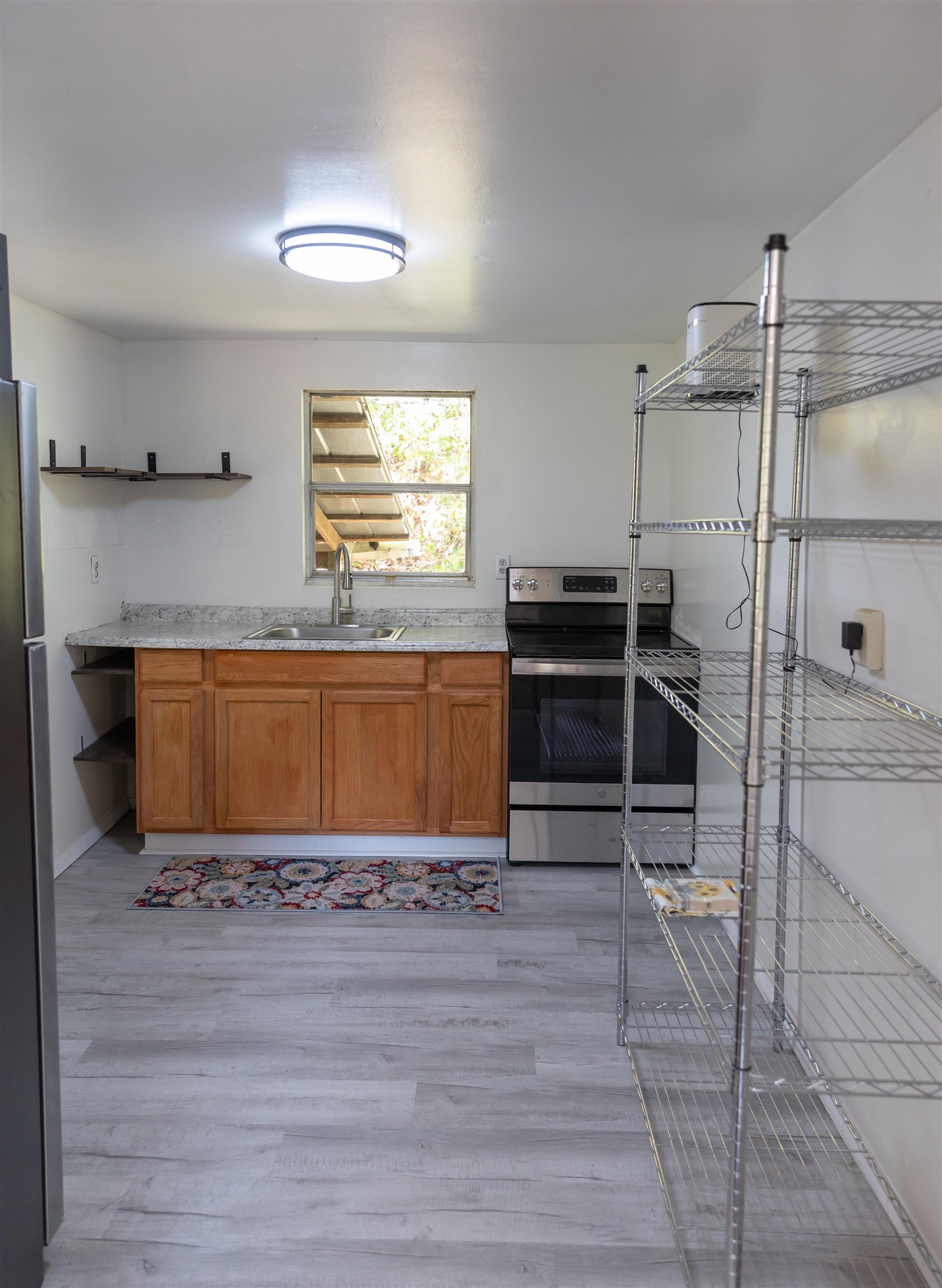 2063 Pedlar River Road Vesuvius, VA 24483 - Photo 13 of 35 a kitchen with stainless steel appliances cabinets and a table