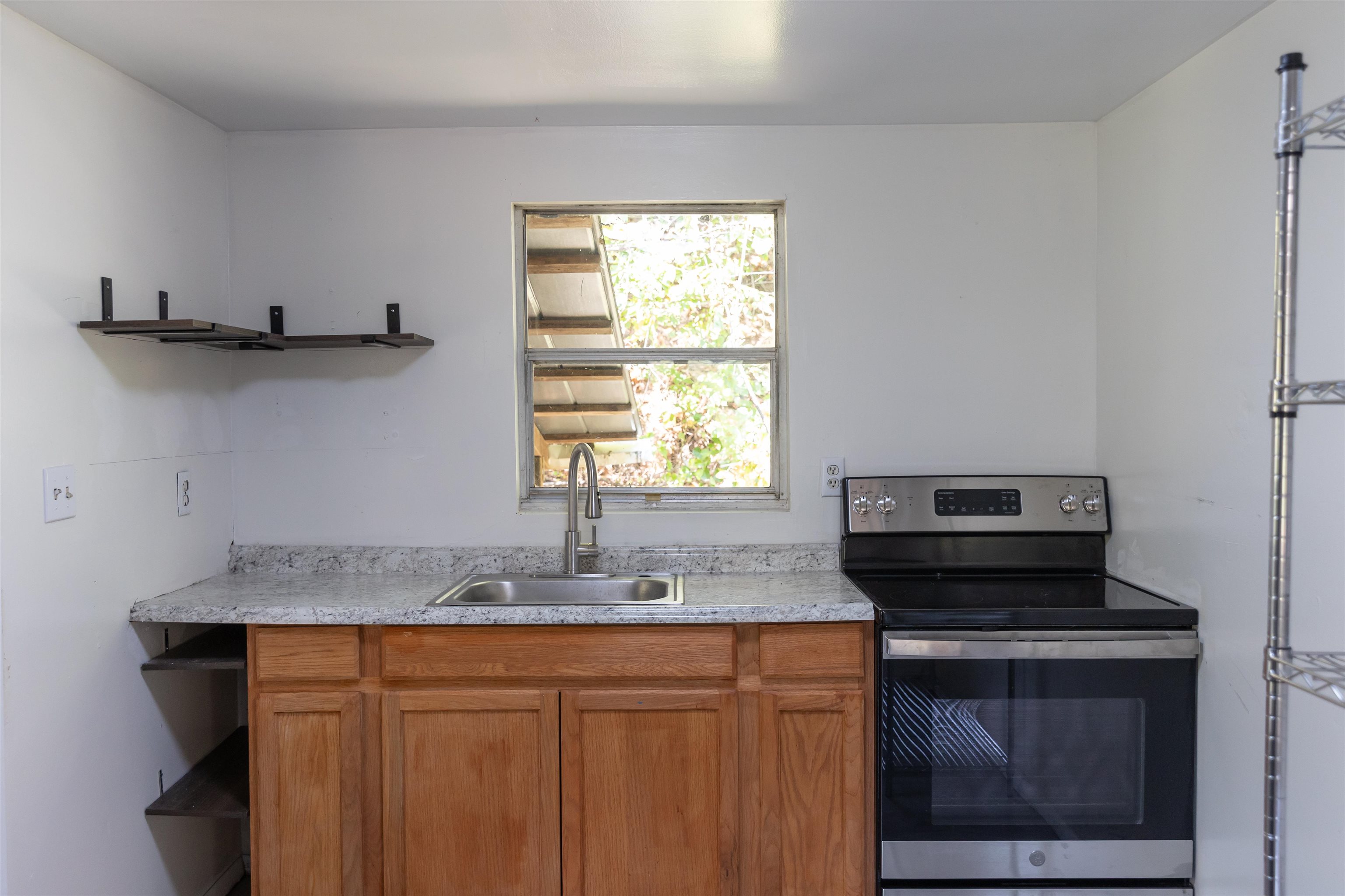 2063 Pedlar River Road Vesuvius, VA 24483 - Photo 14 of 35 a kitchen with stainless steel appliances granite countertop a sink a stove and a microwave