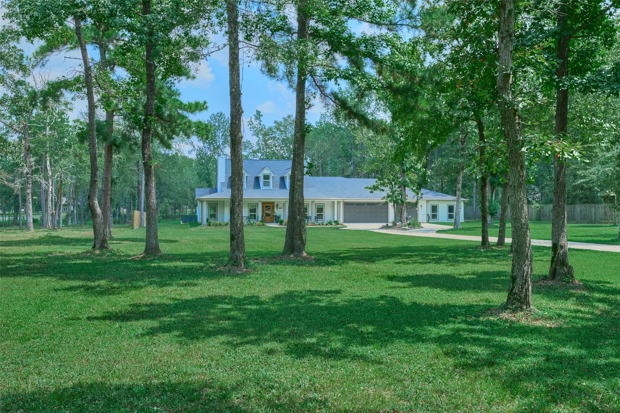 2218 Honea Egypt Road Magnolia, TX 77354 - Photo 2 of 50 Discover spacious living with this expansive 7-bedroom home featuring 4 modern bathrooms and a fully-equipped in-law suite. Enjoy the convenience of automated sprinkler systems for both the front and rear lush lawns.