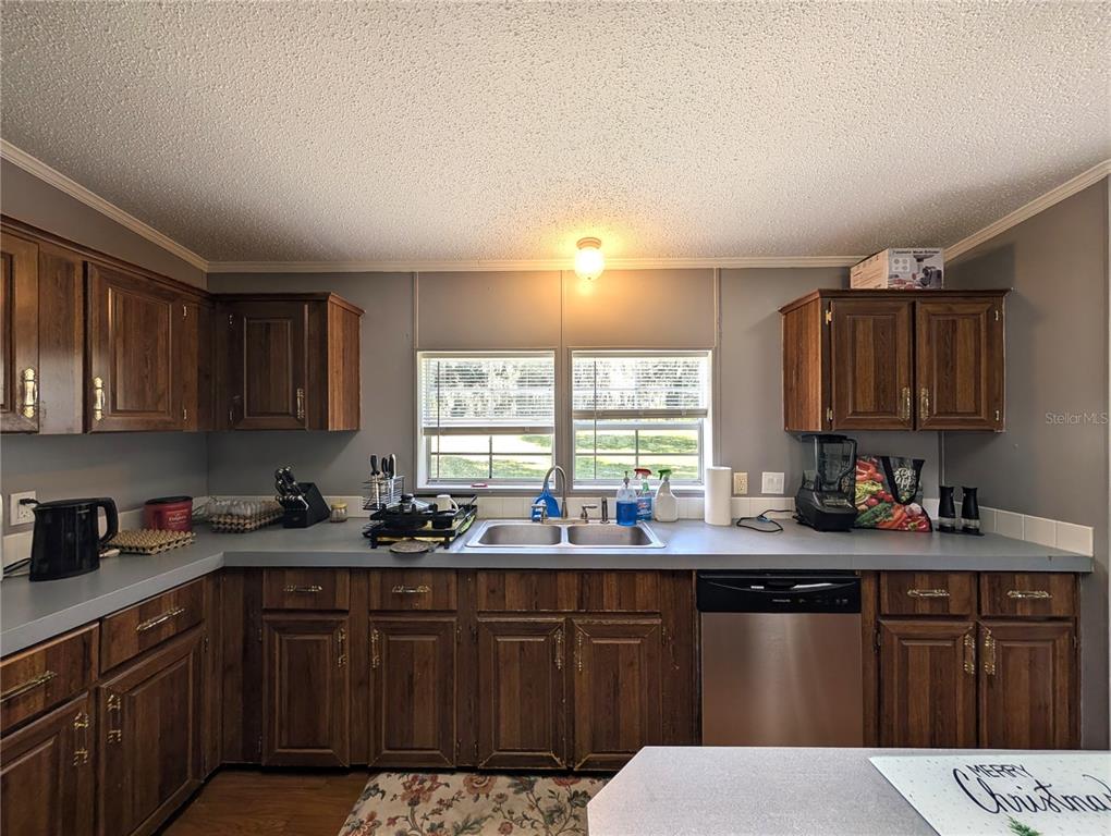 123 Amos Road Crescent City, FL 32112 - Photo 7 of 36 a kitchen with a sink and cabinets
