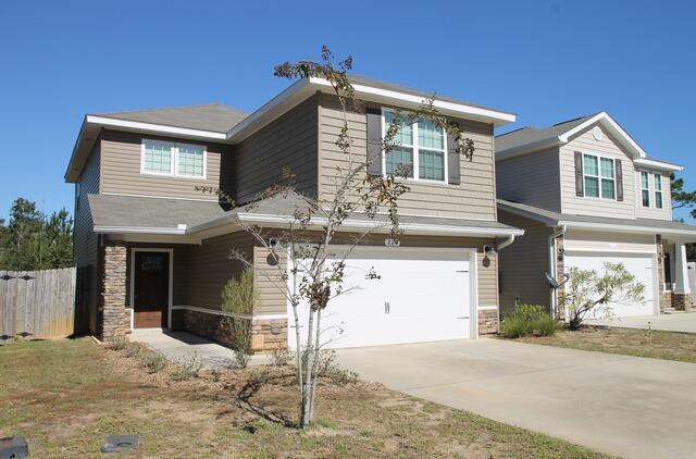 a front view of a house with a garage
