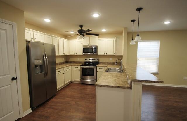 220 Wainwright Drive Crestview, FL 32539 - Photo 2 of 25 a kitchen with stainless steel appliances granite countertop a refrigerator a stove a sink and a microwave