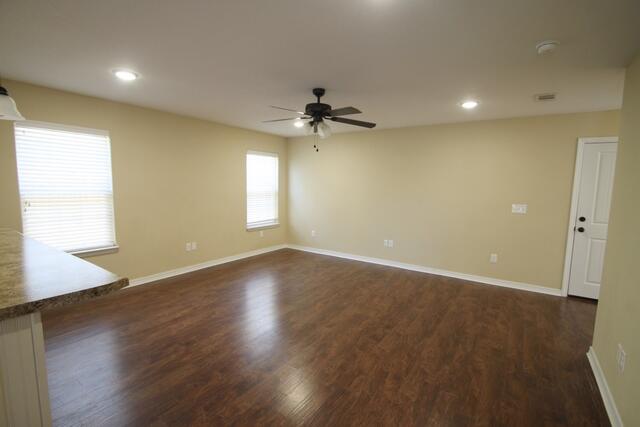 220 Wainwright Drive Crestview, FL 32539 - Photo 12 of 25 a view of a room with wooden floor and a ceiling fan