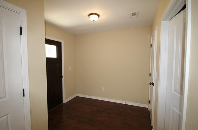220 Wainwright Drive Crestview, FL 32539 - Photo 15 of 25 a view of an empty room with wooden floor and a window