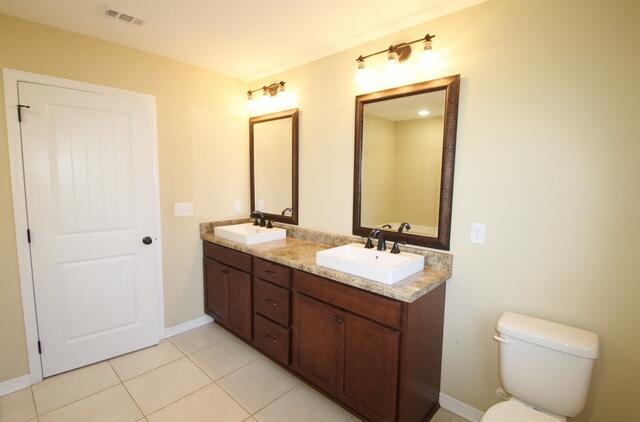 220 Wainwright Drive Crestview, FL 32539 - Photo 20 of 25 a bathroom with a double vanity sink mirror and toilet