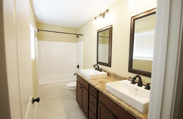 220 Wainwright Drive Crestview, FL 32539 - Photo 4 of 25 a bathroom with a sink double vanity mirror and a bathtub