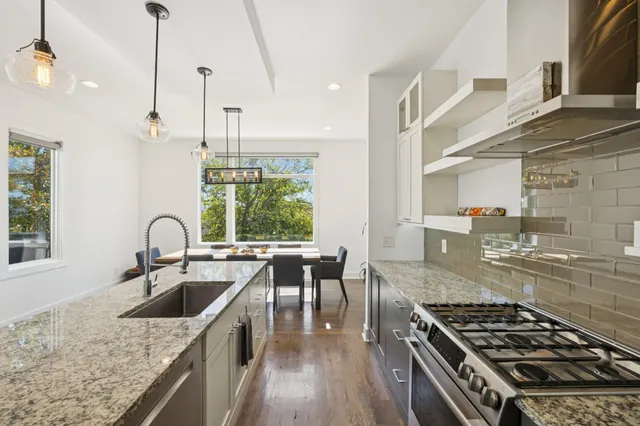 a view of a livingroom with wooden floor and a flat screen tv