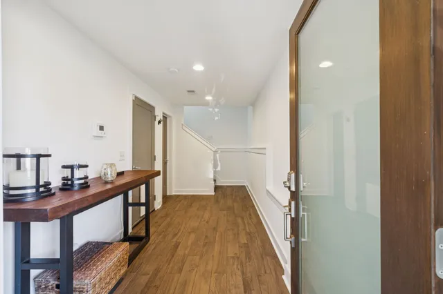a view of a patio with table and chairs and potted plants with wooden floor and wall