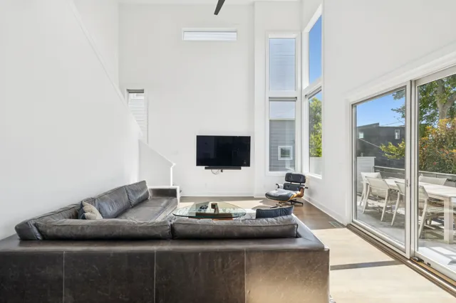 a living room with furniture and a glass door shower