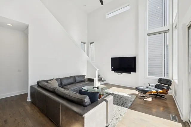 a kitchen with stainless steel appliances granite countertop a sink a refrigerator a stove and a wooden floors