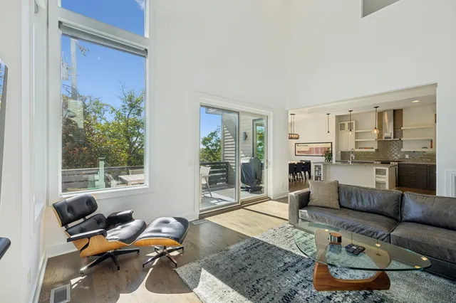 a kitchen with stainless steel appliances granite countertop a sink a stove and a wooden floors