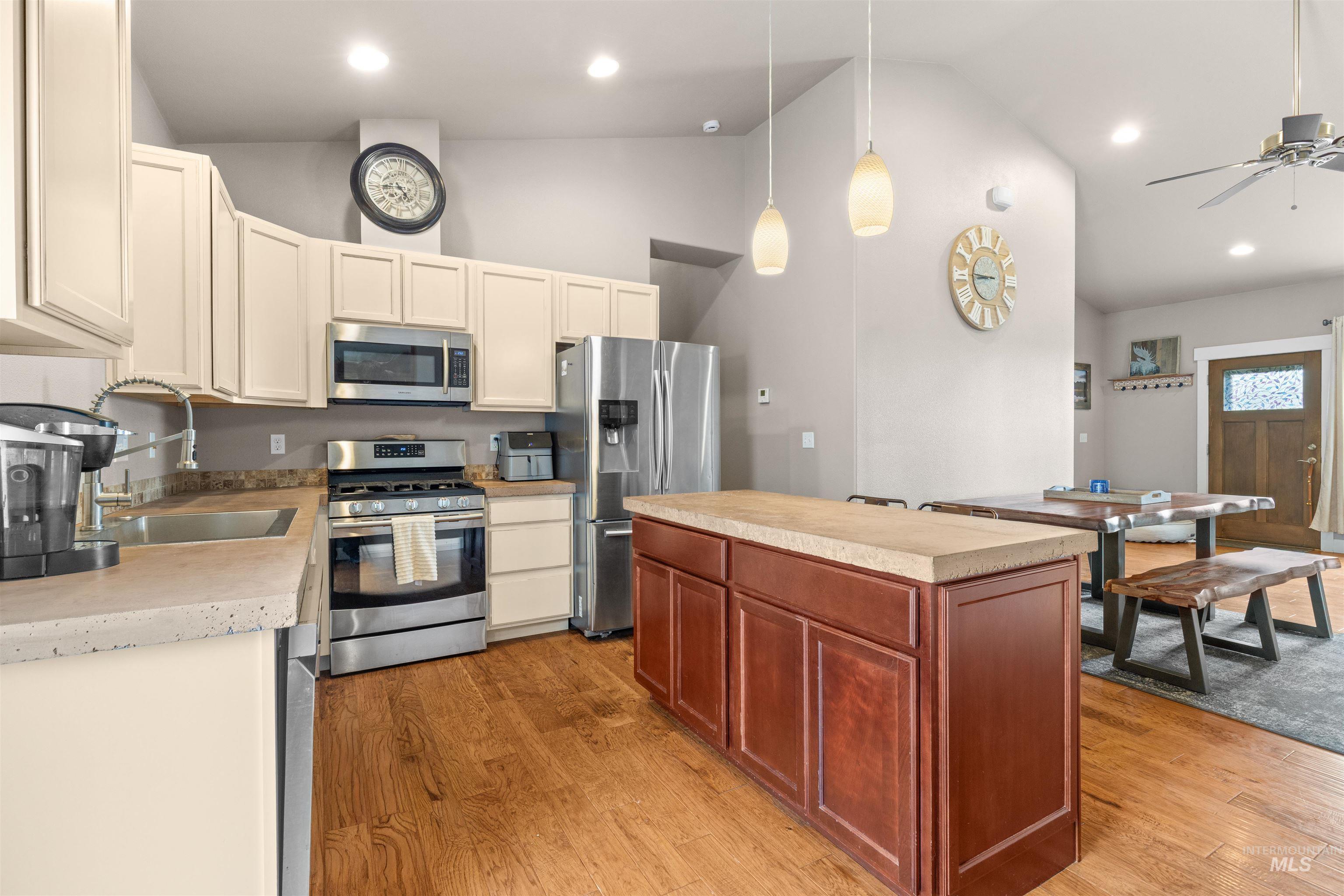 3810 21st Street Lewiston, ID 83501 - Photo 11 of 39 Kitchen featuring stainless steel appliances, a center island, light countertops, light wood-type flooring, and lofted ceiling