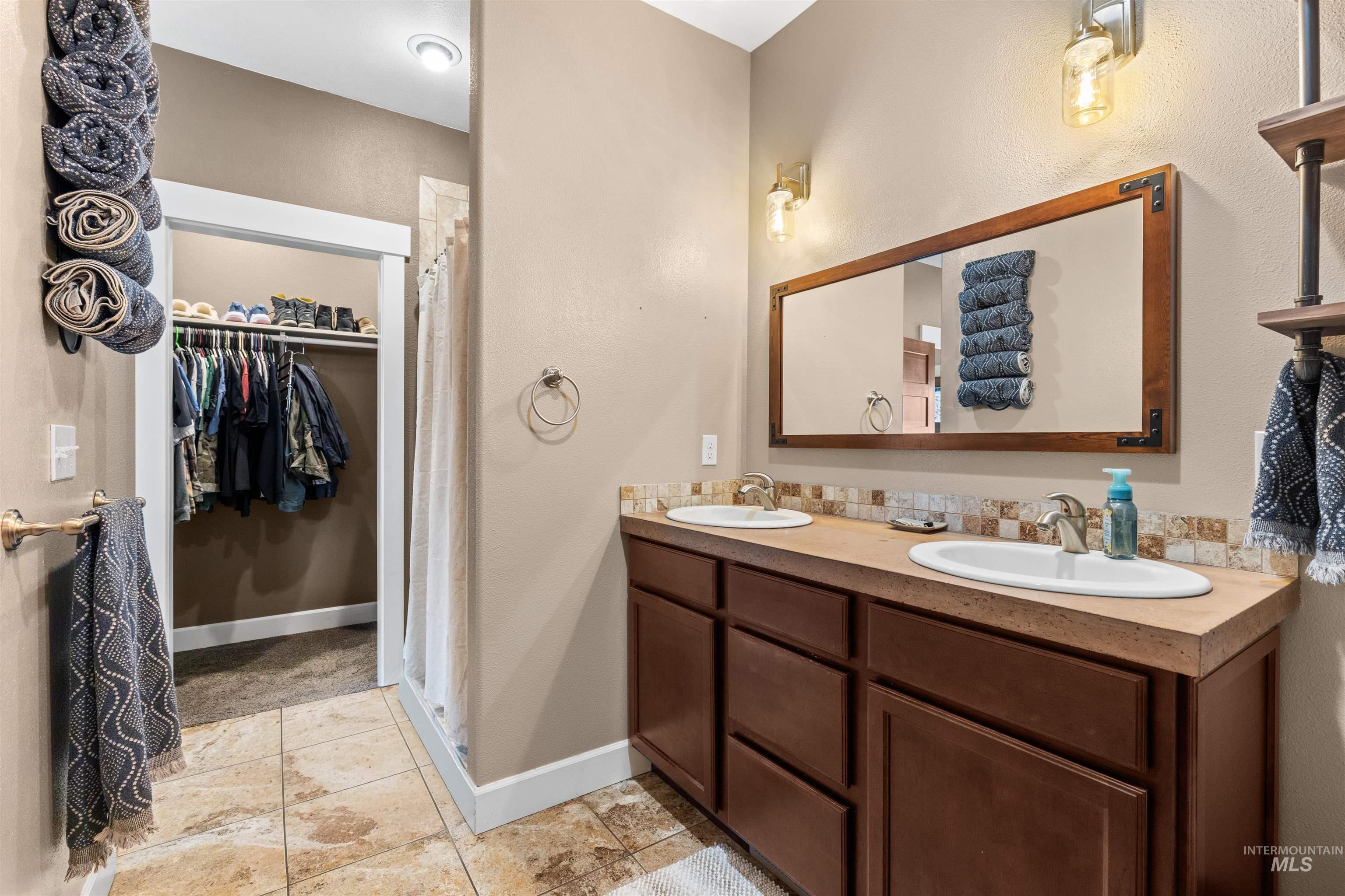 3810 21st Street Lewiston, ID 83501 - Photo 17 of 39 Full bath featuring double vanity, a stall shower, and a walk in closet