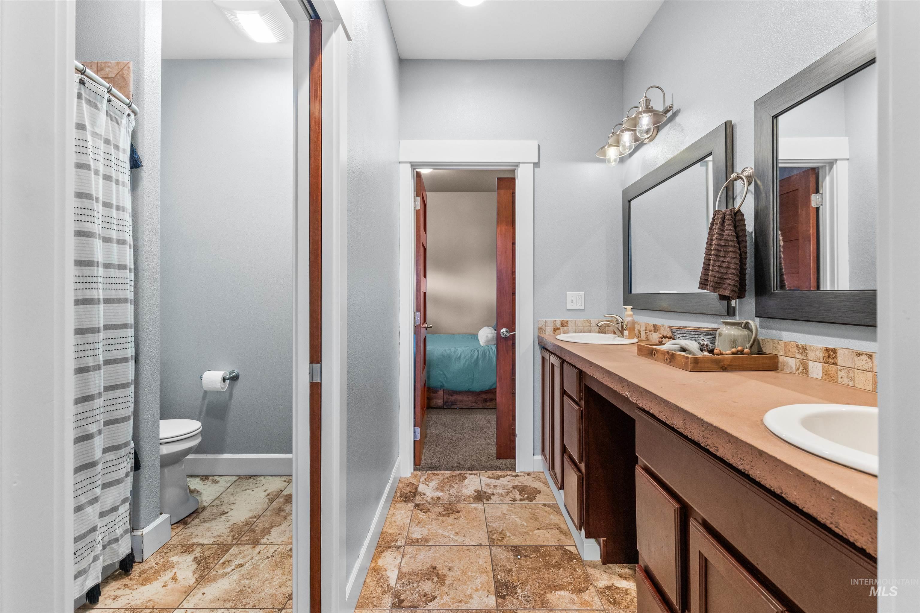 3810 21st Street Lewiston, ID 83501 - Photo 20 of 39 Ensuite bathroom with double vanity and a shower with curtain