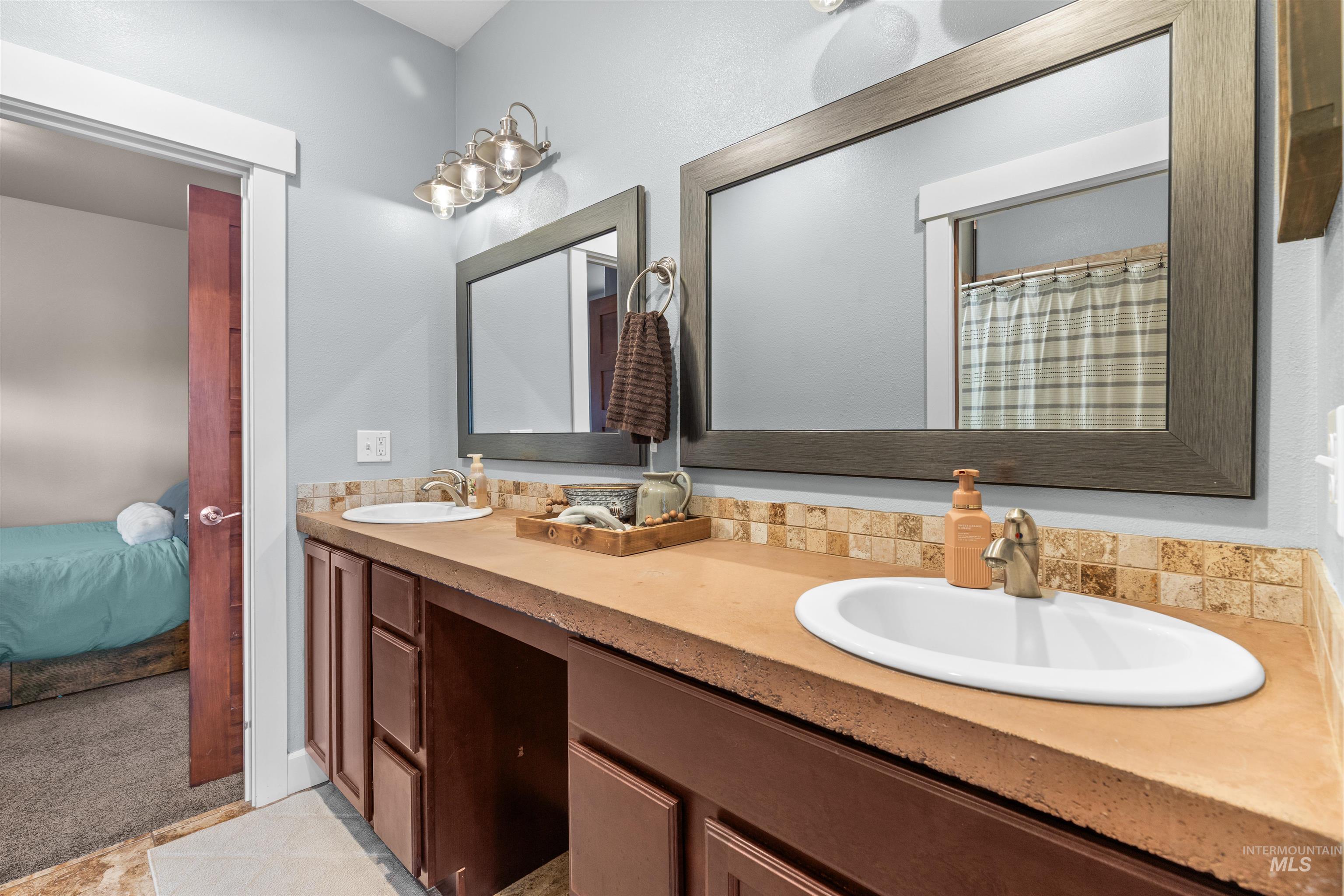 3810 21st Street Lewiston, ID 83501 - Photo 21 of 39 Bathroom with double vanity, ensuite bathroom, a shower with curtain, and light colored carpet