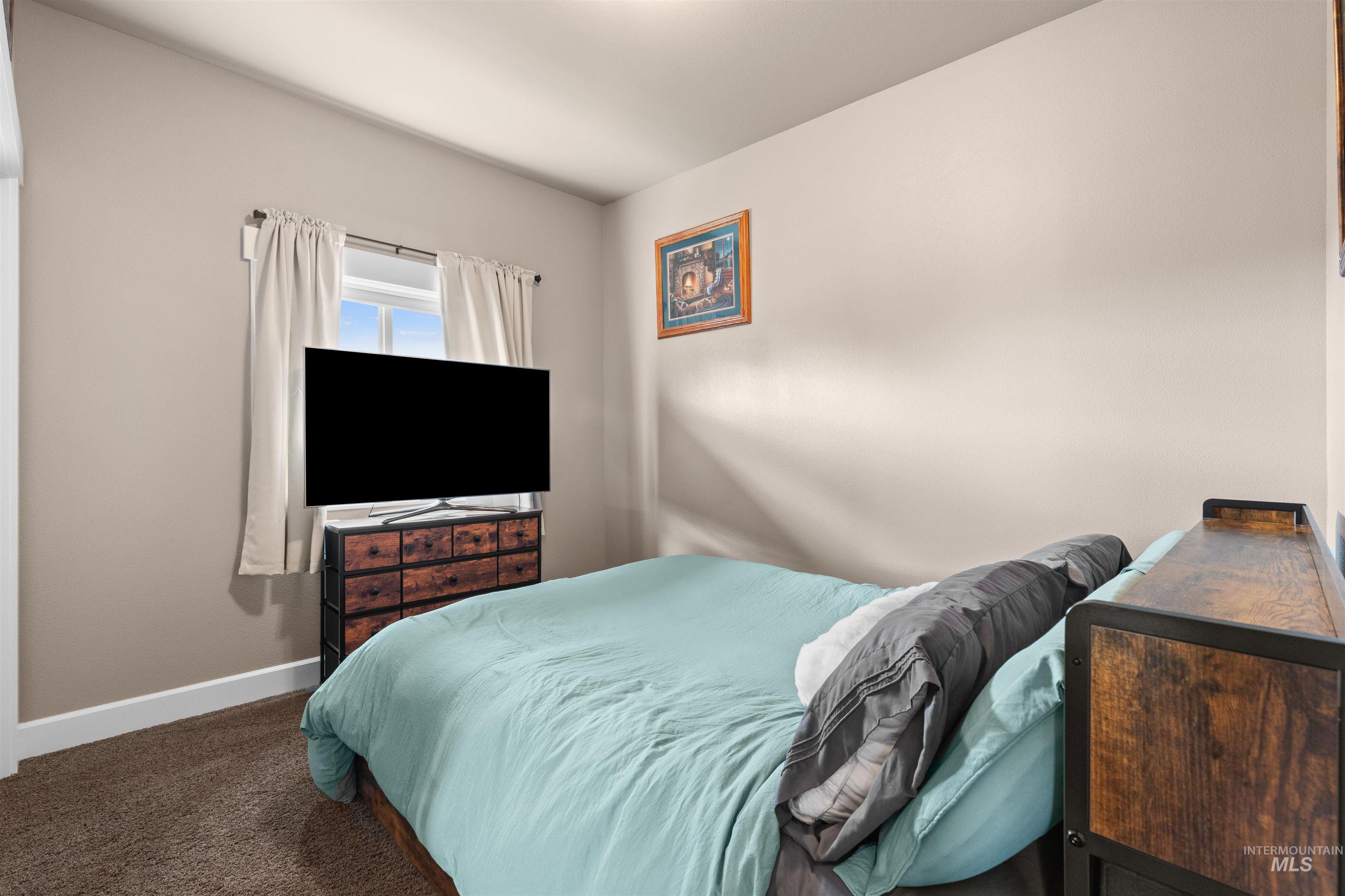 3810 21st Street Lewiston, ID 83501 - Photo 24 of 39 Bedroom featuring baseboards and dark colored carpet