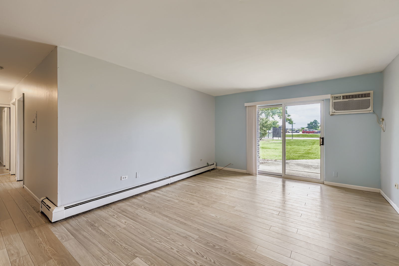 870 Winesap Court, Unit 103 Prospect Heights, IL 60070 - Photo 2 of 11 a view of an empty room with wooden floor and a window
