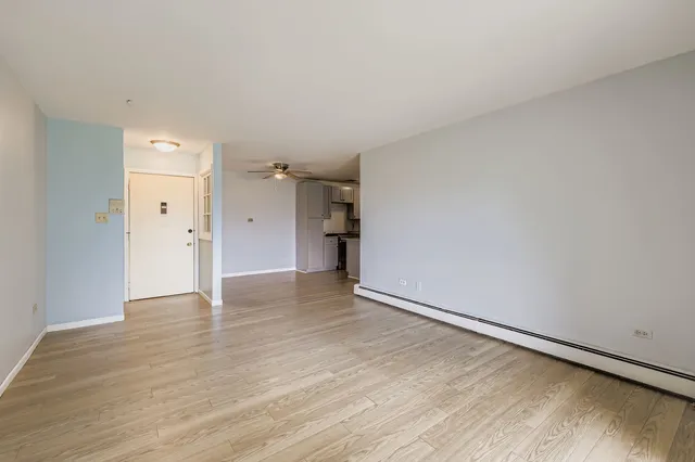 a view of an empty room and wooden floor