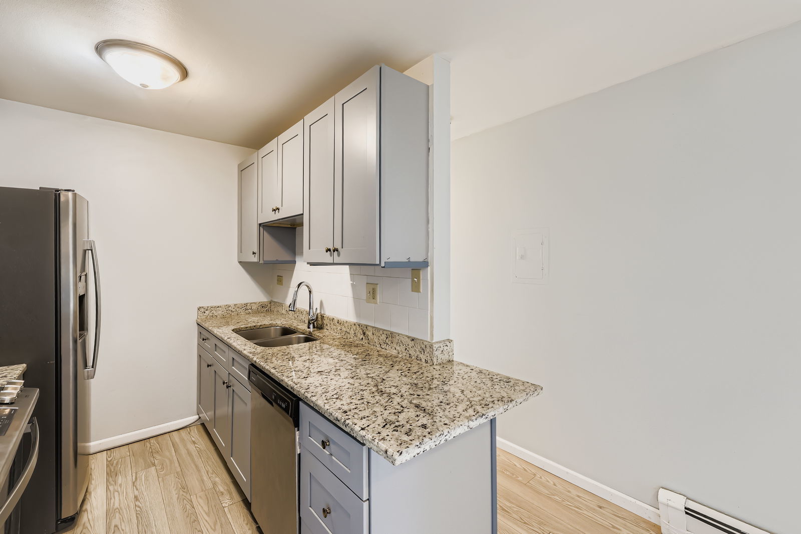 870 Winesap Court, Unit 103 Prospect Heights, IL 60070 - Photo 4 of 11 a kitchen with stainless steel appliances granite countertop a sink stove and refrigerator