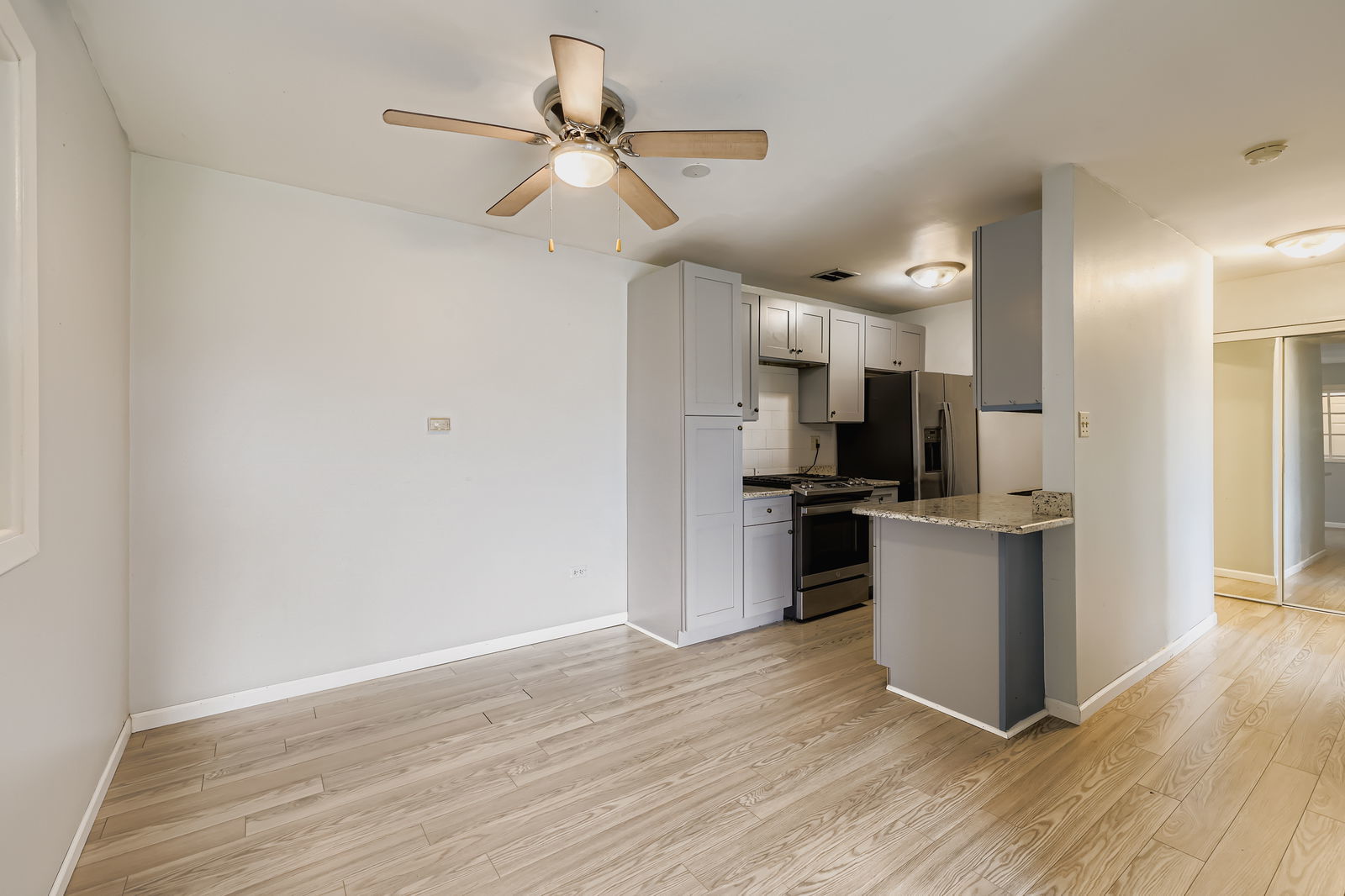 870 Winesap Court, Unit 103 Prospect Heights, IL 60070 - Photo 6 of 11 a kitchen with a refrigerator and white cabinets
