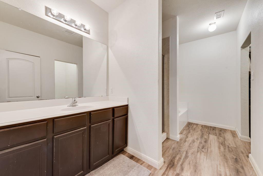 2907 Kyle Street Anna, TX 75409 - Photo 12 of 25 a bathroom with a double vanity sink and a mirror