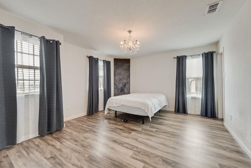 2907 Kyle Street Anna, TX 75409 - Photo 16 of 25 a bedroom with a bed and wooden floor