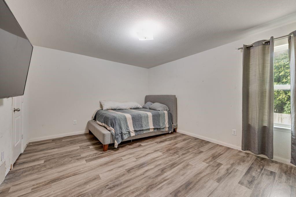 2907 Kyle Street Anna, TX 75409 - Photo 19 of 25 a bedroom with a bed and wooden floor
