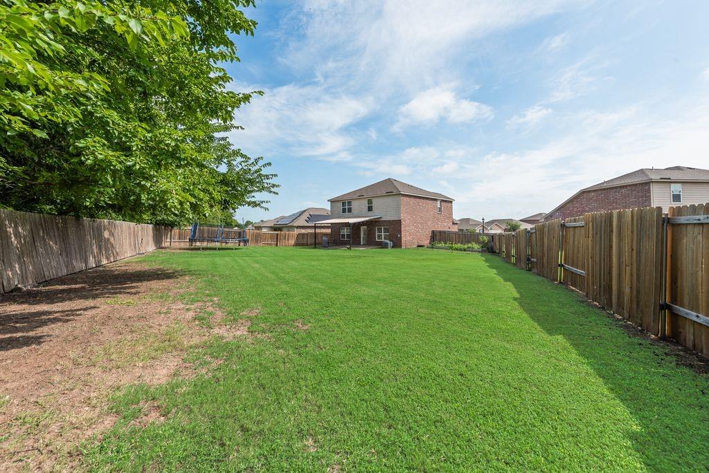 2907 Kyle Street Anna, TX 75409 - Photo 21 of 25 a view of a house with backyard and a tree