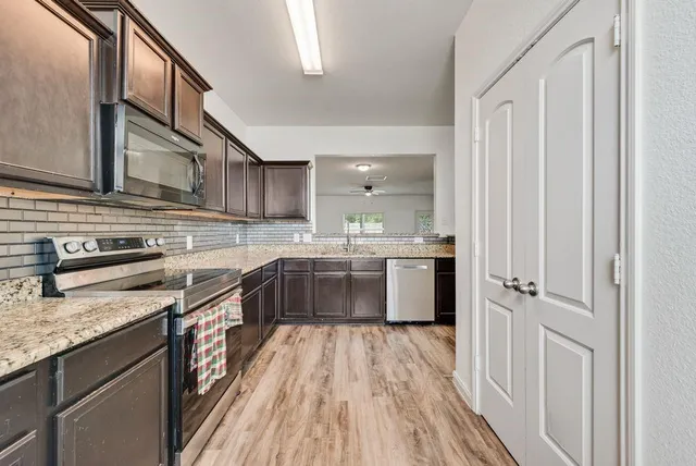 a kitchen with stainless steel appliances granite countertop a stove and a sink