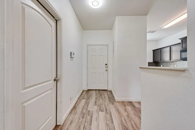 a view of a kitchen from the hallway