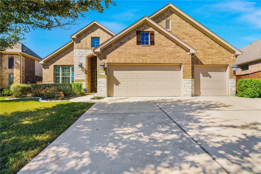 2657 Outlook Ridge Loop Leander, TX 78641 - Photo 1 of 1 The stylish exterior blends brick and stone siding with a 3 car garage and beautiful landscaping along the sidewalk that leads to the front door