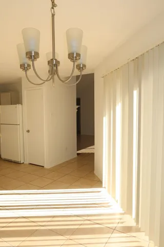 a view of an empty room with a fireplace and a window