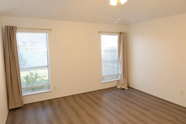 a bathroom with double vanity sinks and a mirror