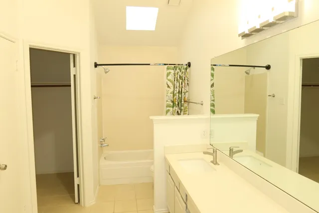 a view of a house with a tree in the yard