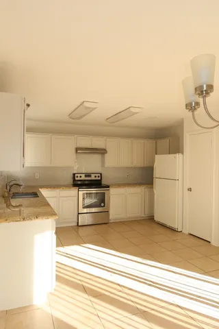 a view of a kitchen counter top and utility room