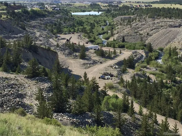 an aerial view of residential house with parking and yard