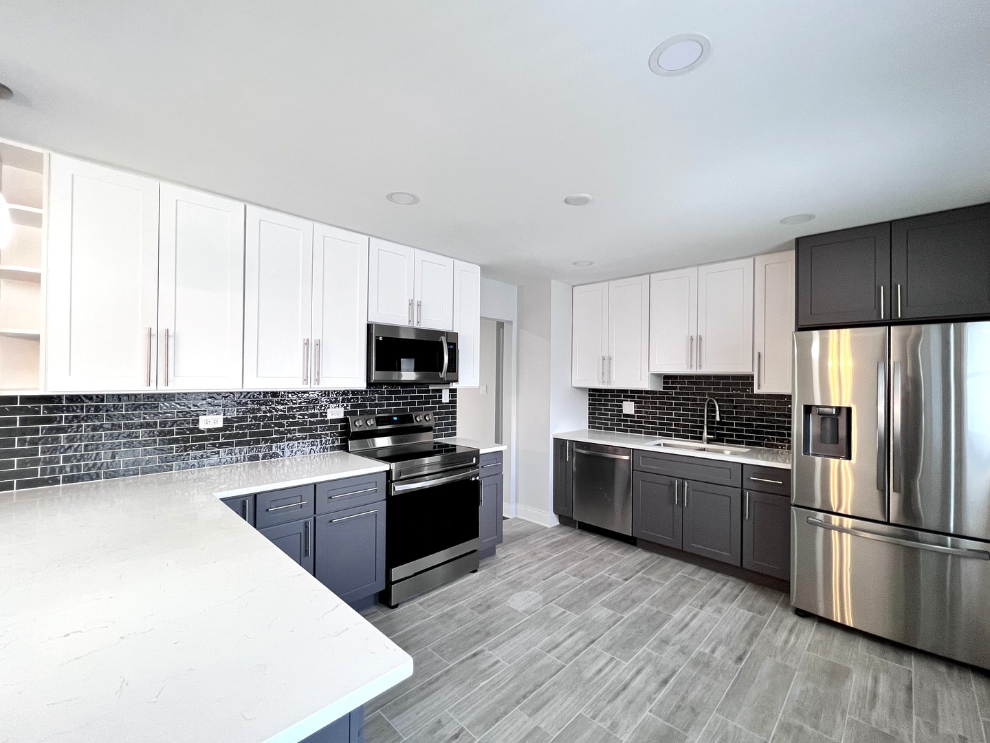 235 North Rohlwing Road Palatine, IL 60074 - Photo 11 of 35 a kitchen with stainless steel appliances granite countertop a stove a sink dishwasher a refrigerator and a stove with wooden floor