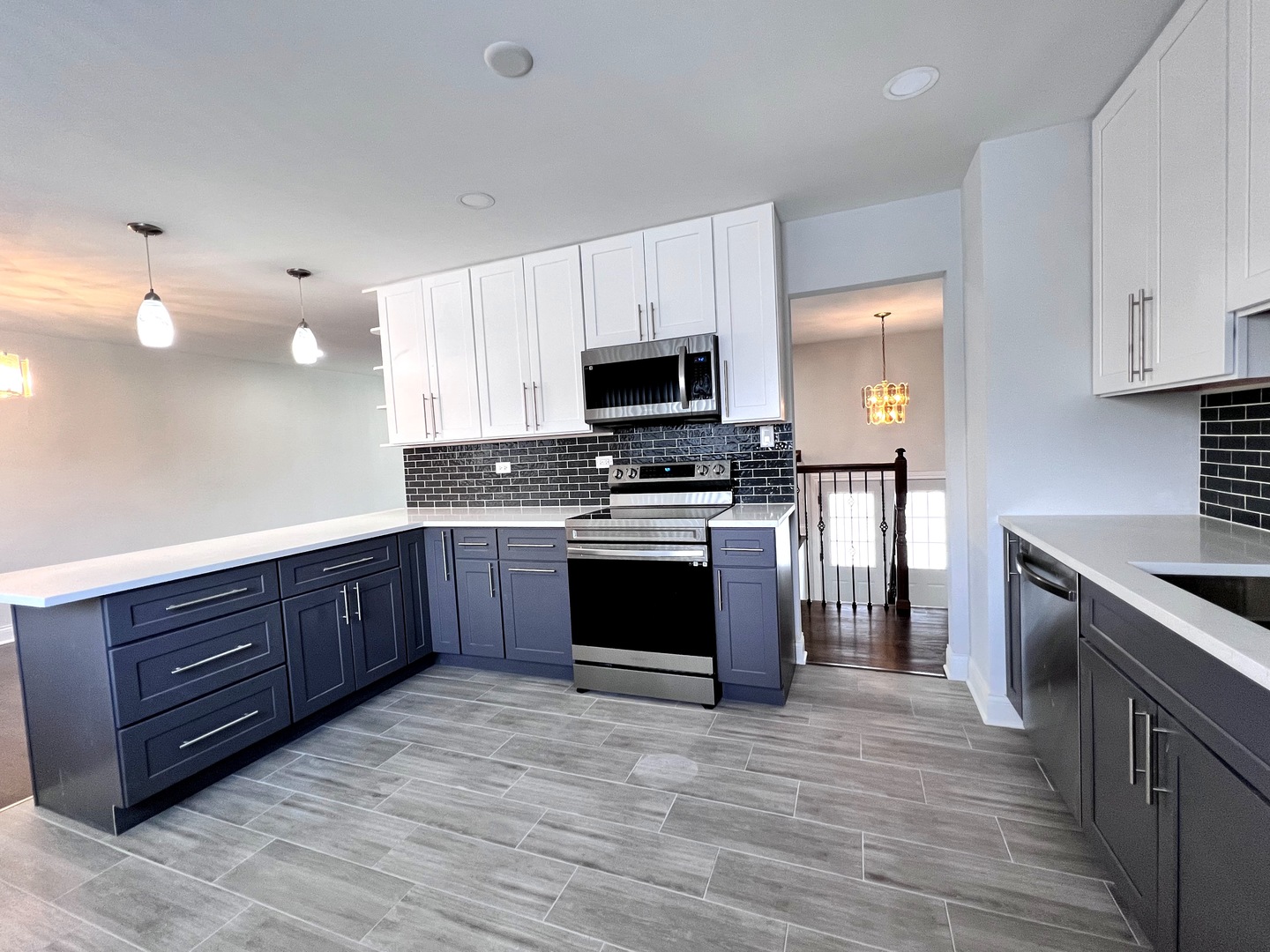 235 North Rohlwing Road Palatine, IL 60074 - Photo 12 of 35 a kitchen with granite countertop a stove top oven and cabinets