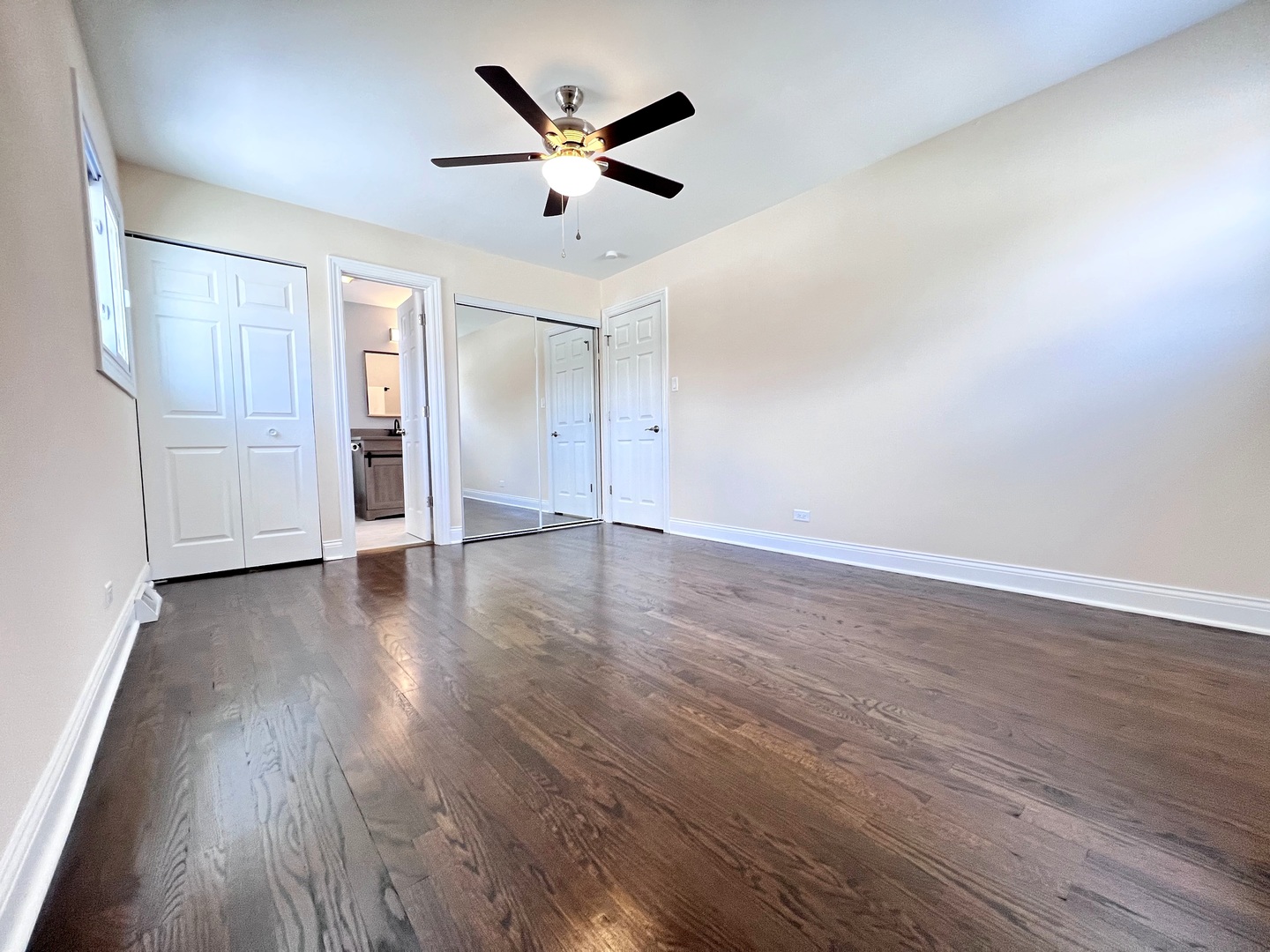 235 North Rohlwing Road Palatine, IL 60074 - Photo 15 of 35 an empty room with wooden floor and ceiling fan