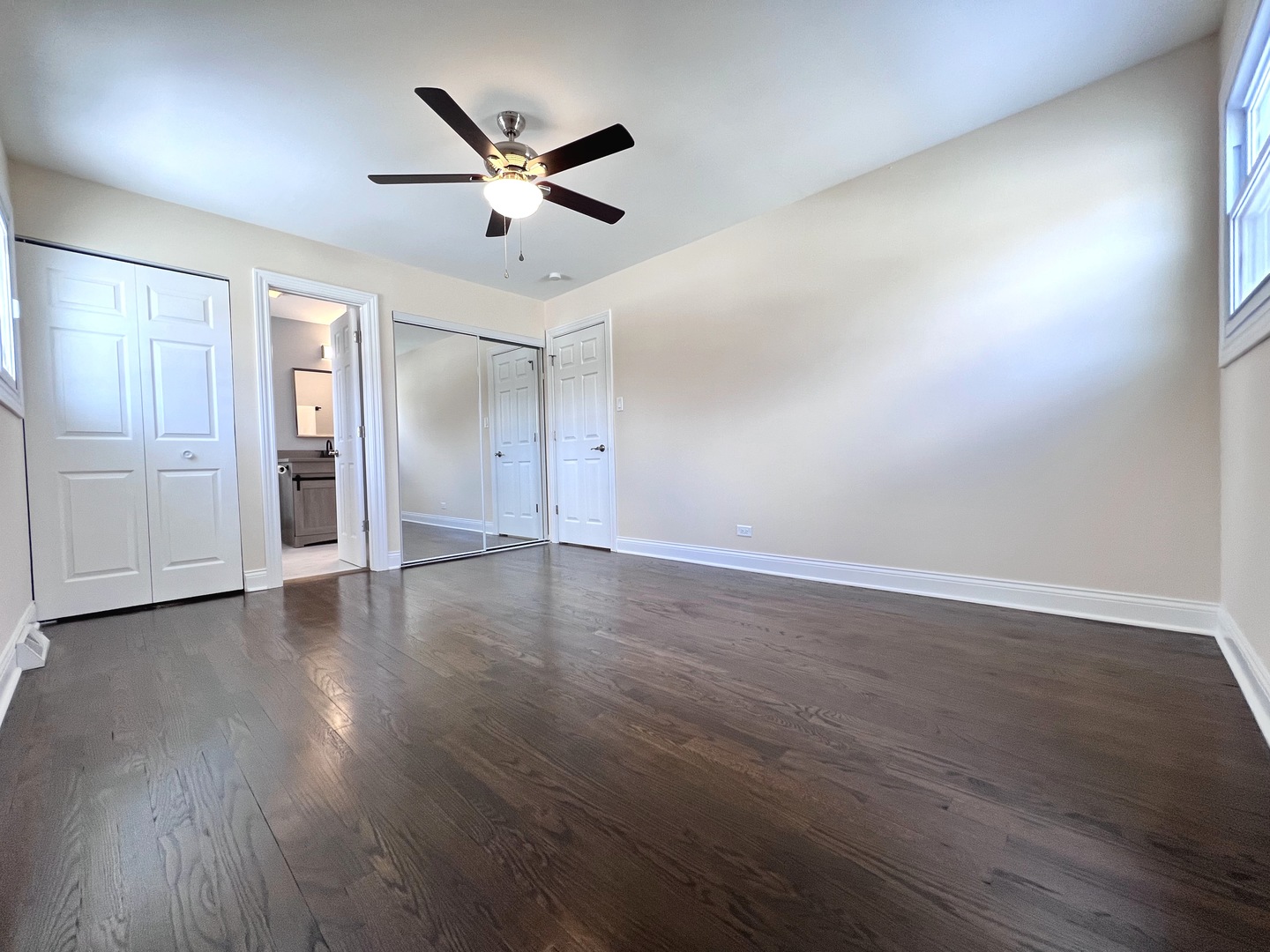 235 North Rohlwing Road Palatine, IL 60074 - Photo 16 of 35 a view of an empty room with wooden floor and a ceiling fan