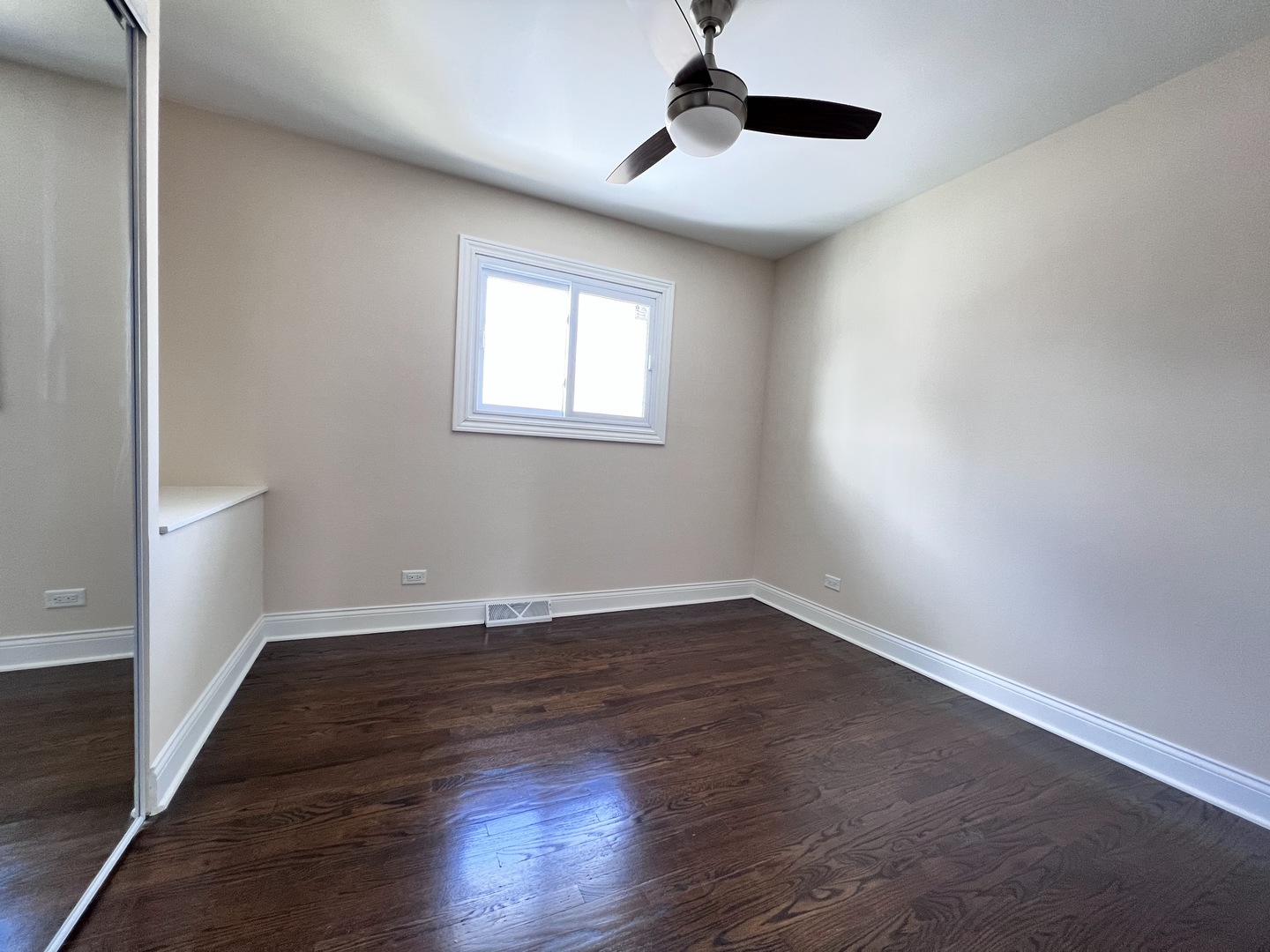 235 North Rohlwing Road Palatine, IL 60074 - Photo 17 of 35 a view of an empty room with wooden floor and a window