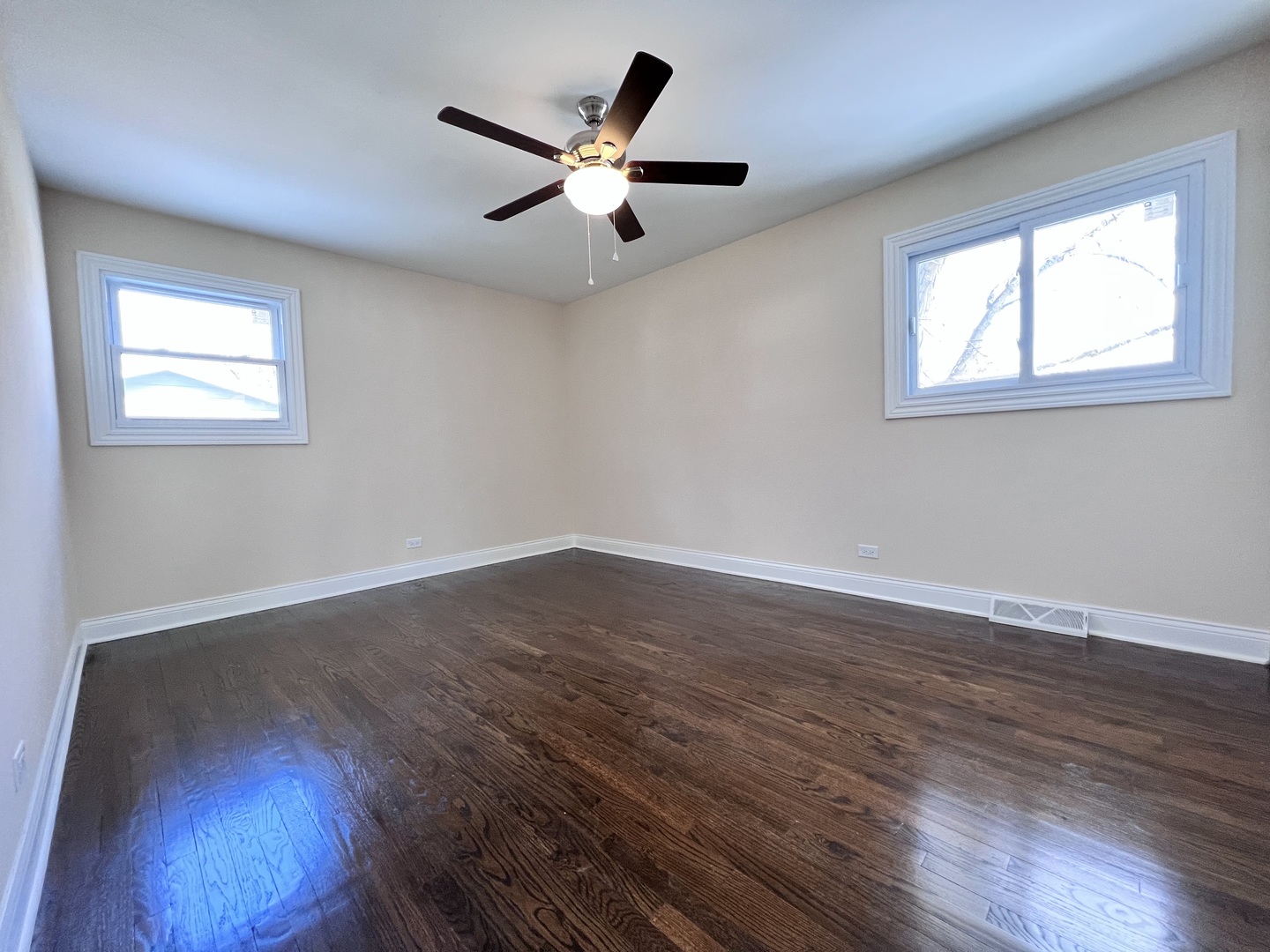 235 North Rohlwing Road Palatine, IL 60074 - Photo 21 of 35 a view of an empty room with wooden floor and a window