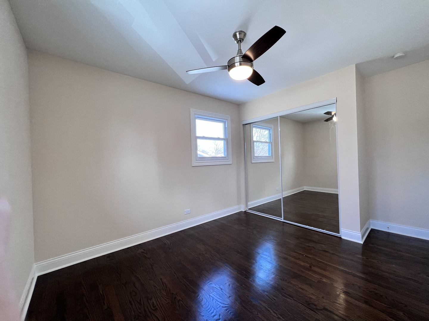 235 North Rohlwing Road Palatine, IL 60074 - Photo 22 of 35 a view of an empty room with wooden floor and a window