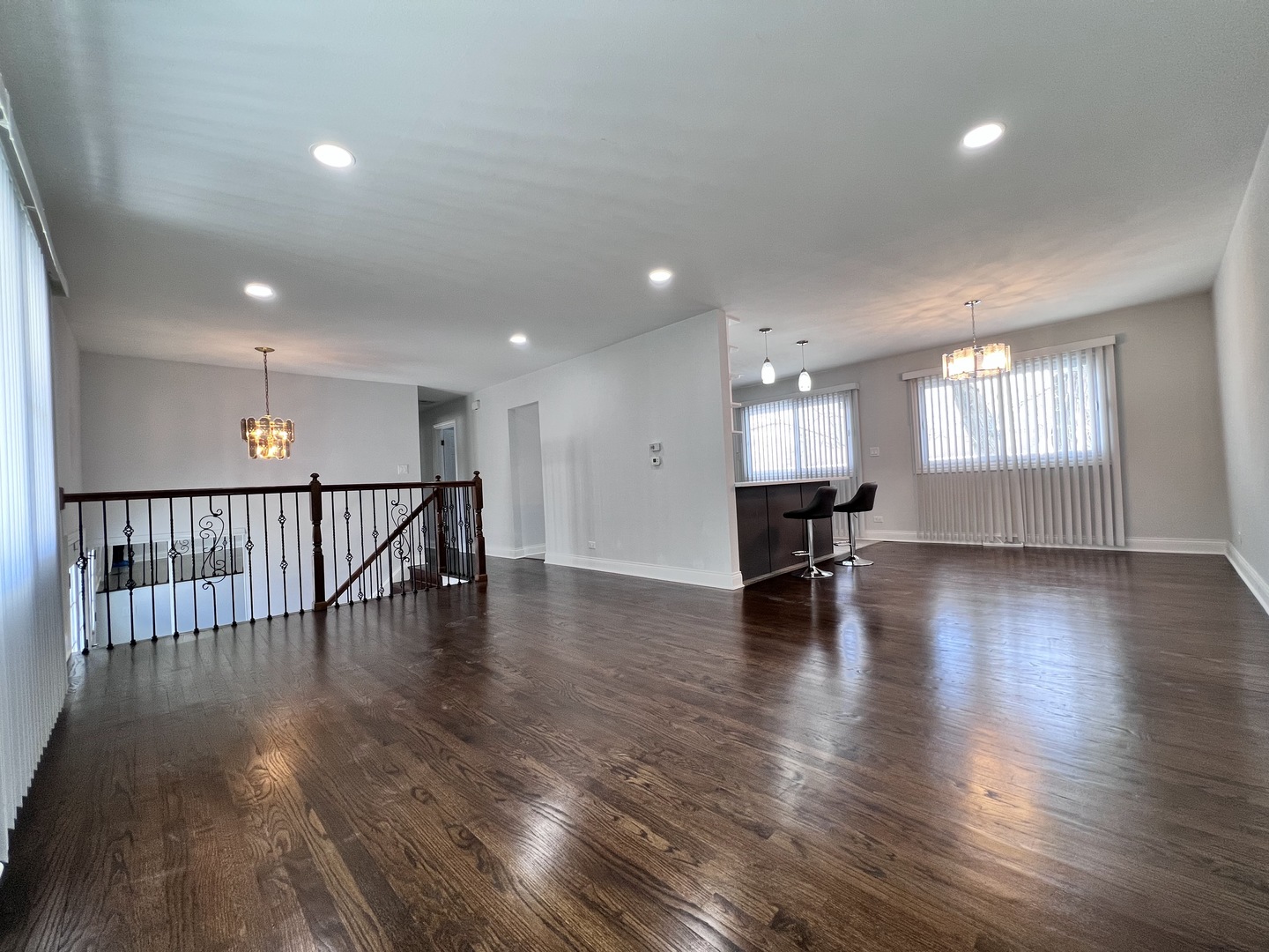 235 North Rohlwing Road Palatine, IL 60074 - Photo 5 of 35 a view of an empty room with wooden floor and a kitchen