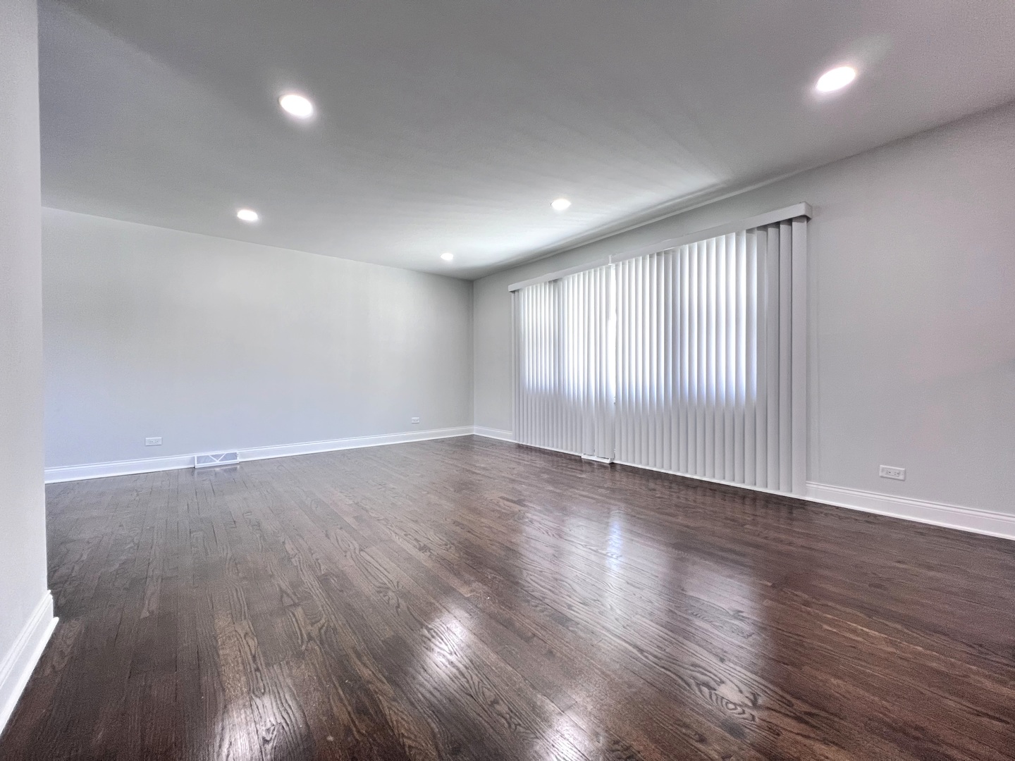 235 North Rohlwing Road Palatine, IL 60074 - Photo 6 of 35 a view of an empty room with wooden floor and a window